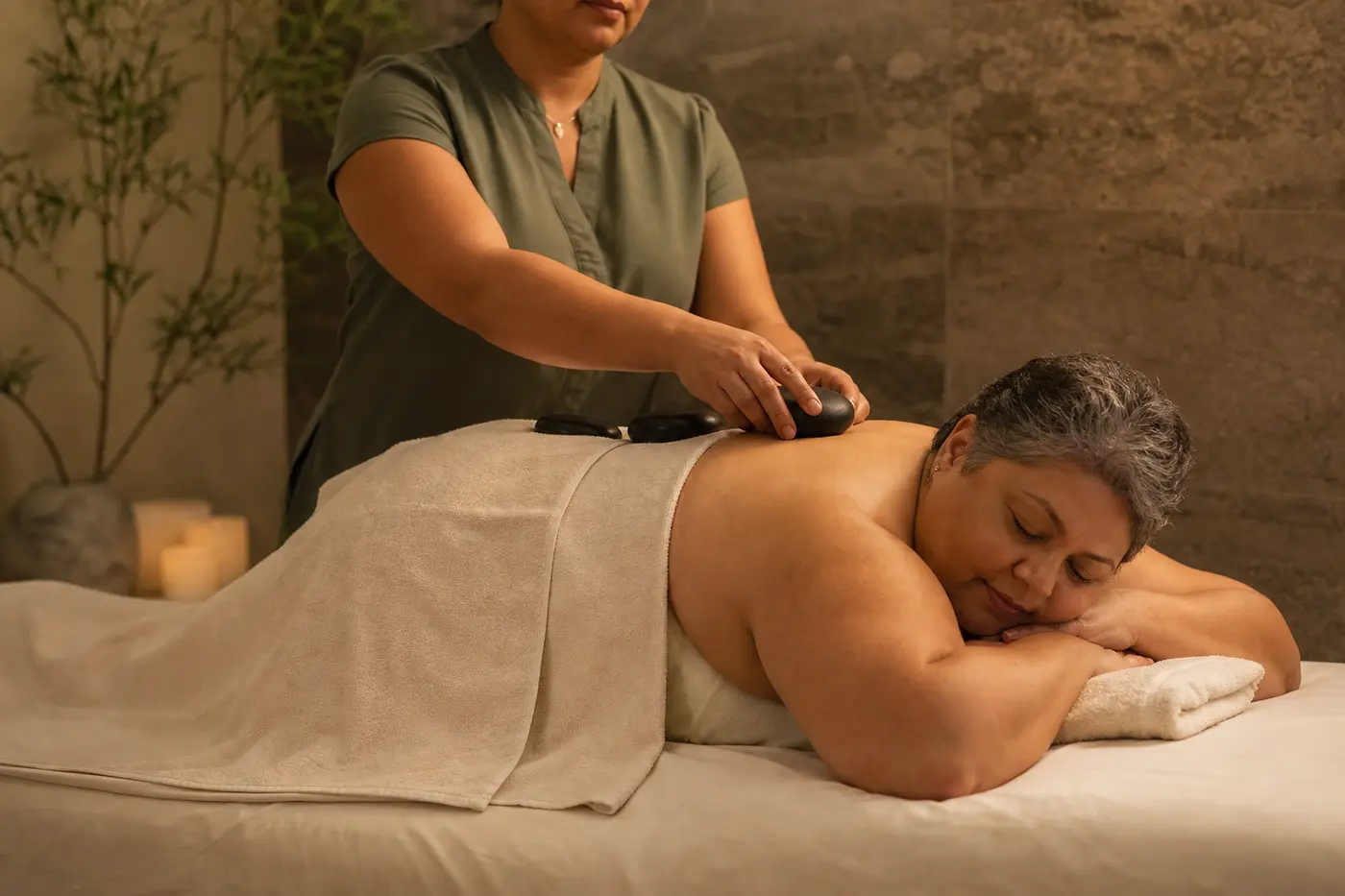 Client enjoying a warm stone body ritual